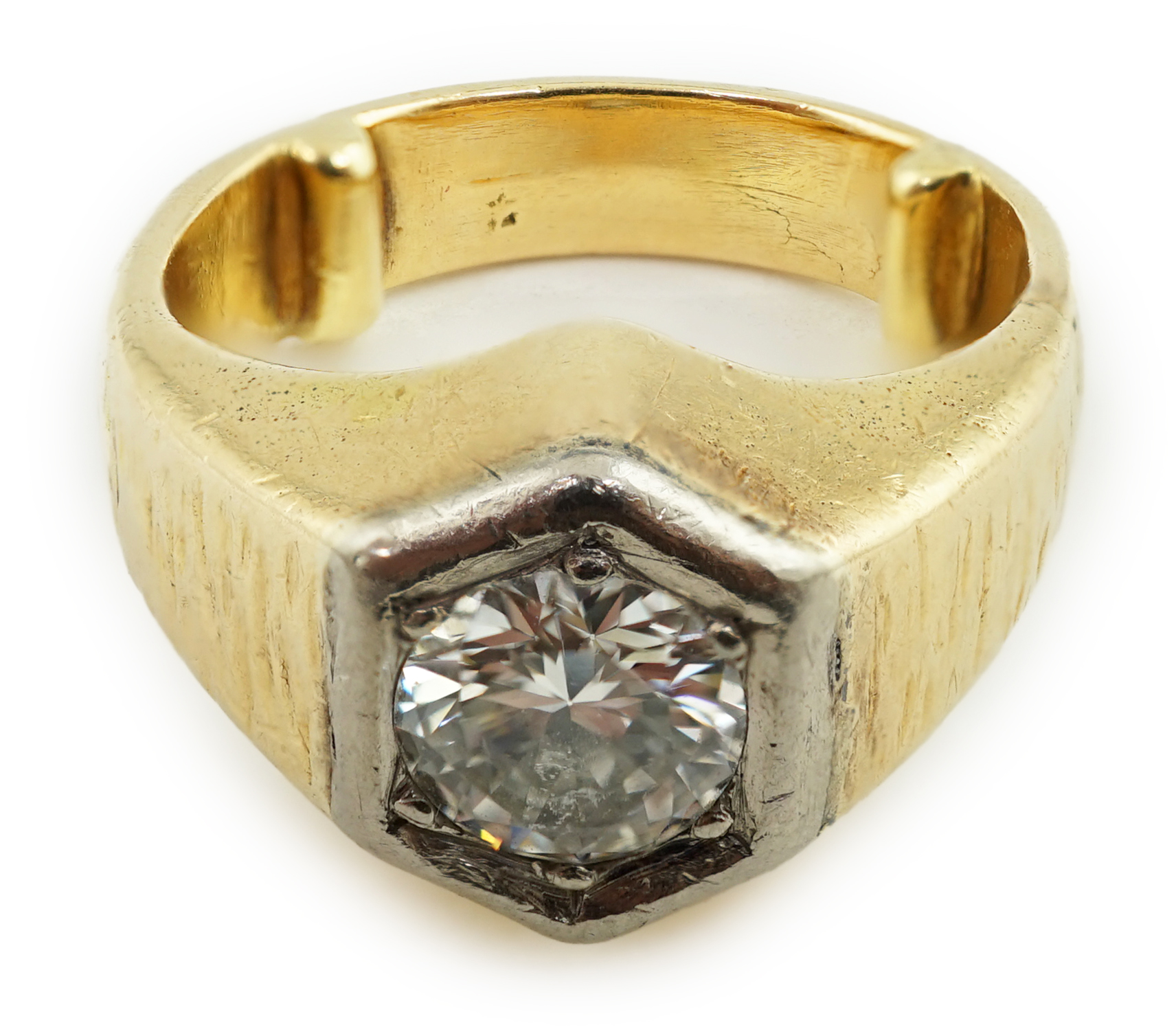 A textured 18ct gold and solitaire diamond set ring